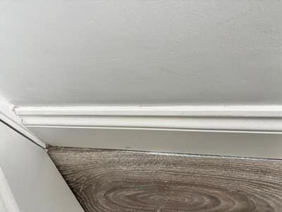 Clean white skirting board along a corner