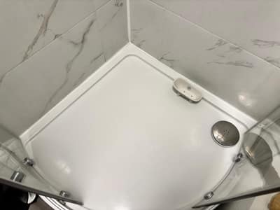Gleaming white shower tray and glass shower screen