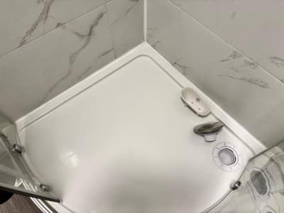 Shower tray during cleaning, with the drain cover lifted