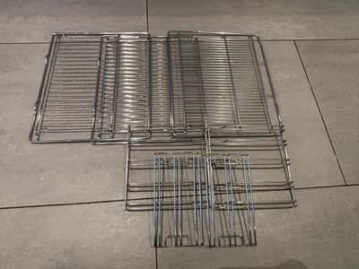 Oven shelves and runners laid out after cleaning