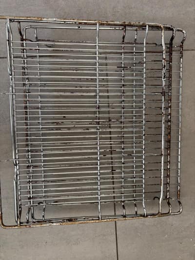 Greasy oven shelf before cleaning