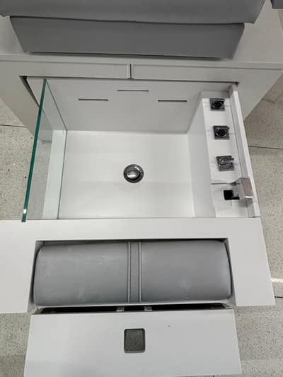 Clean foot spa basin at a salon pedicure chair