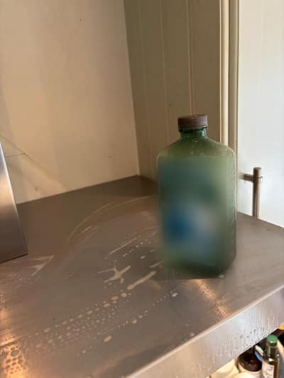 Cooker hood top with cleaner during cleaning