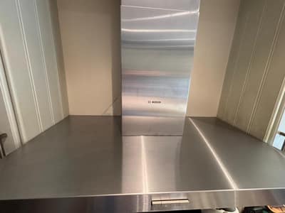 Polished stainless steel cooker hood after cleaning
