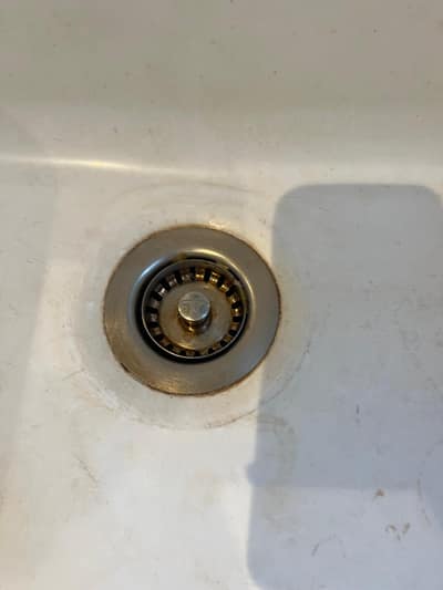 Close-up of a sink plughole after cleaning