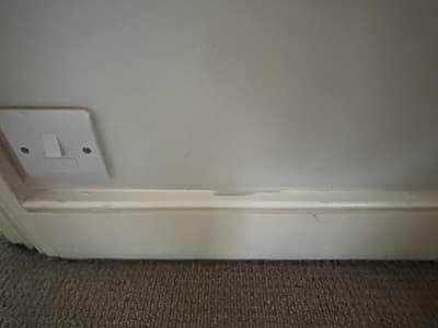 Skirting board beside a light switch after cleaning